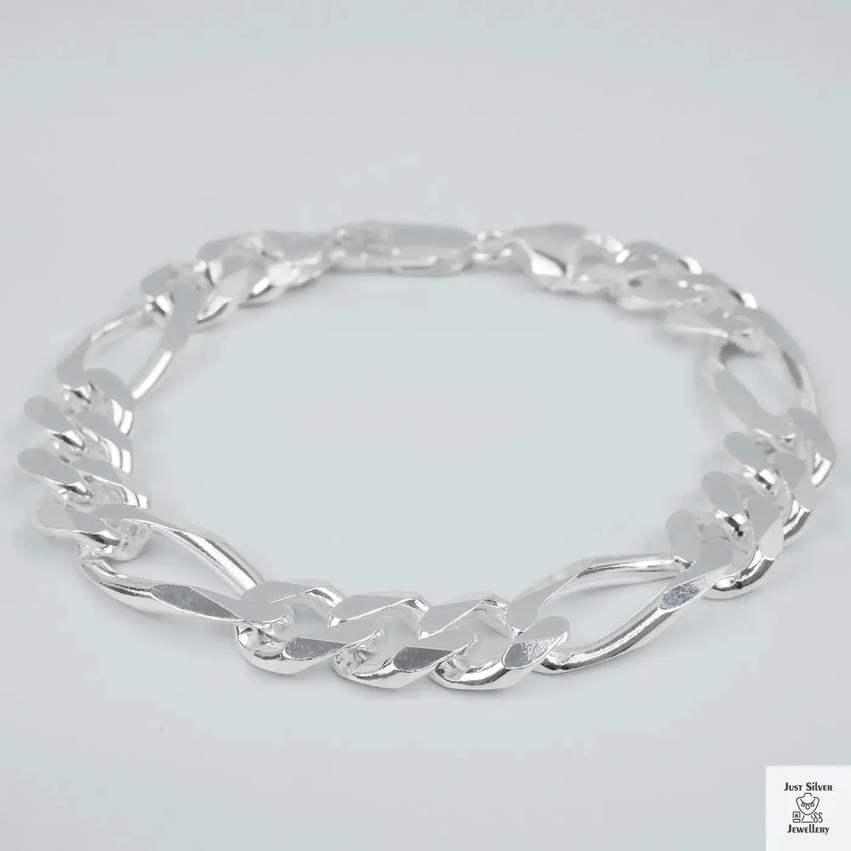 Silver bracelet on a light grey background