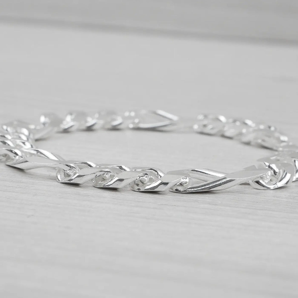 Silver bracelet on a light grey background