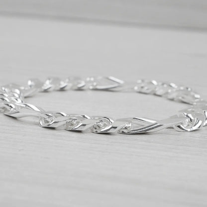 Silver bracelet on a light grey background