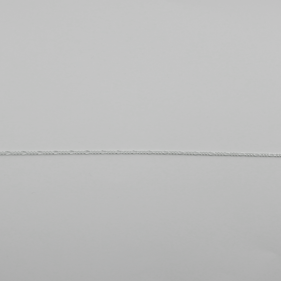 Close-up of a gray fabric with a subtle texture and visible seam.