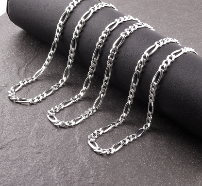 Silver chain necklace on a dark surface