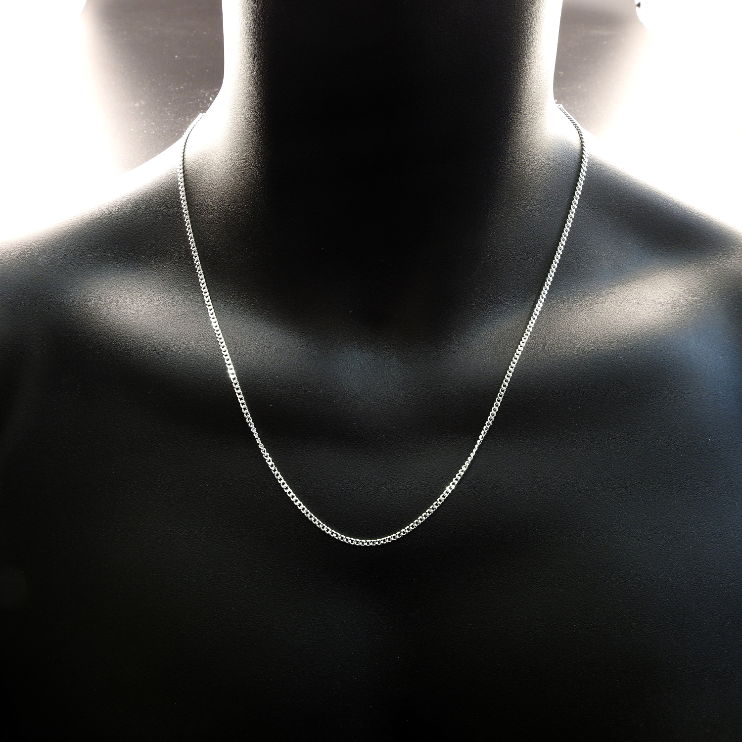 Silver chain necklace on a black mannequin