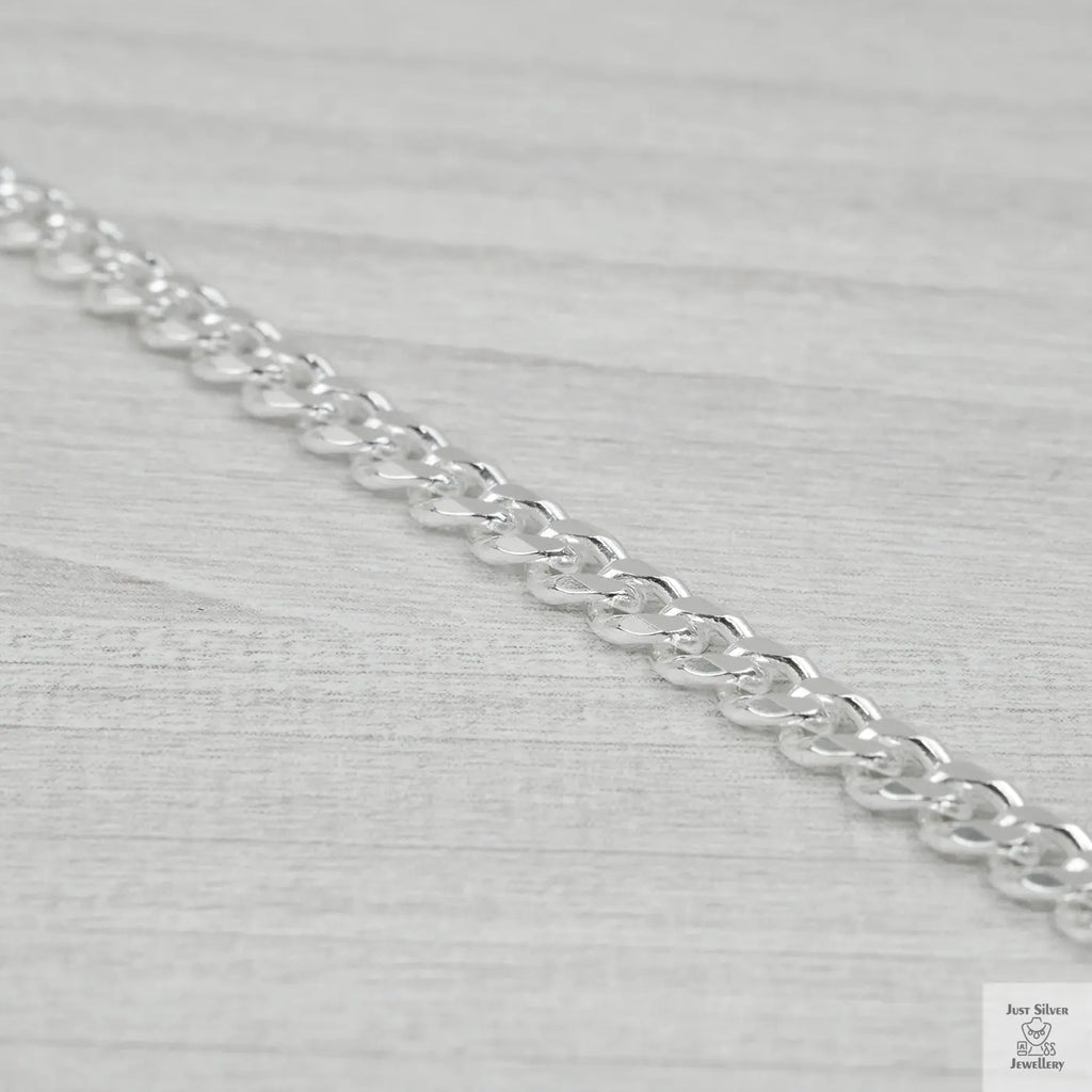 Silver bracelet on a light grey background