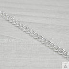Silver bracelet on a light grey background