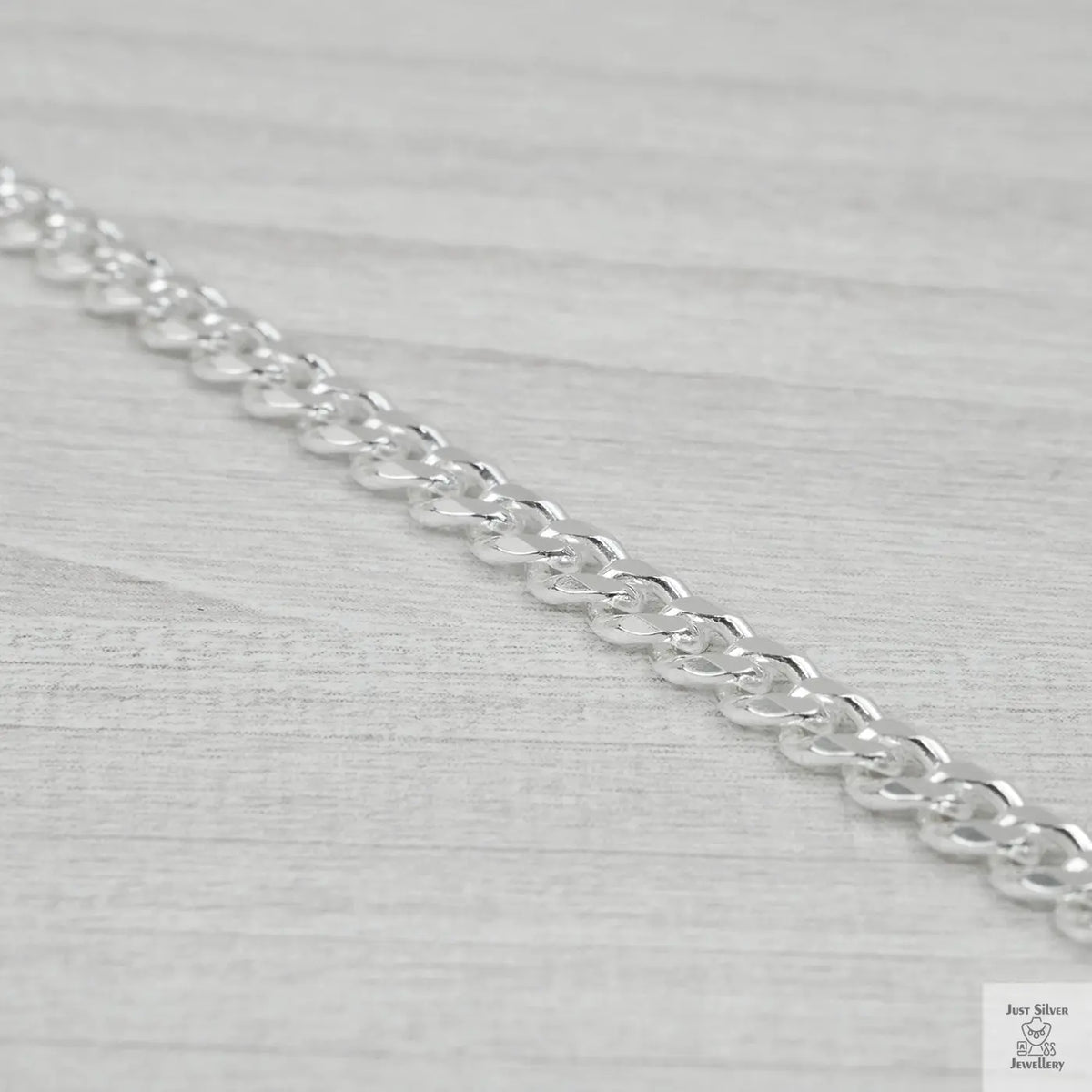 Silver bracelet on a light grey background