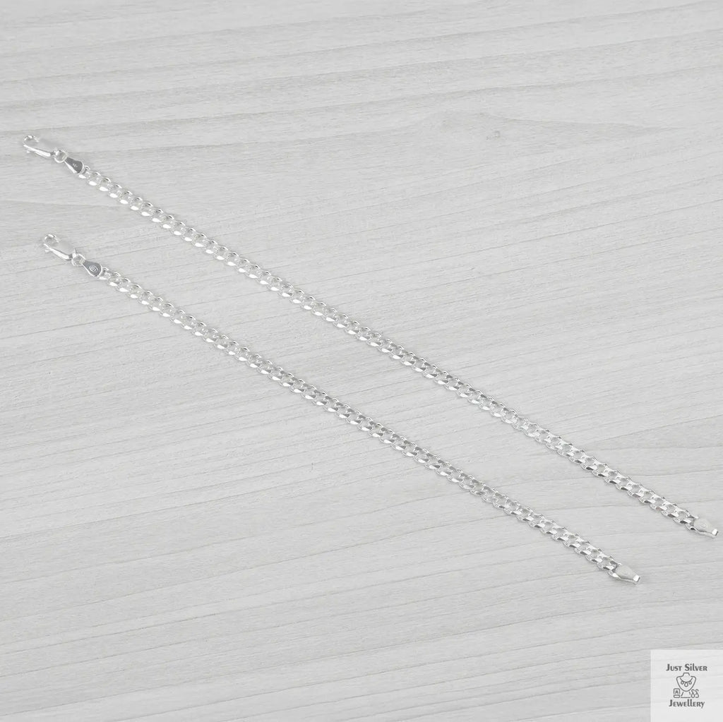 Silver bracelets on a textured grey surface