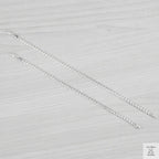 Silver bracelets on a textured grey surface