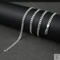 Silver curb chain on a dark surface