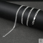 Silver curb chain on a dark surface
