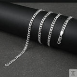 Silver curb chain on a dark surface