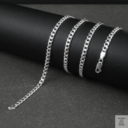 Silver curb chain on a dark surface