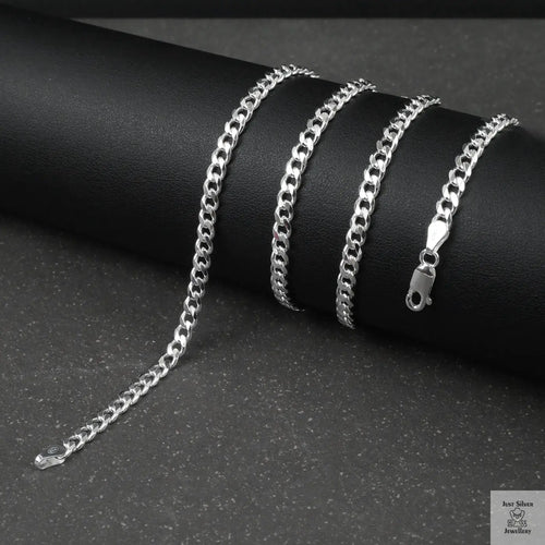 Silver curb chain on a dark surface