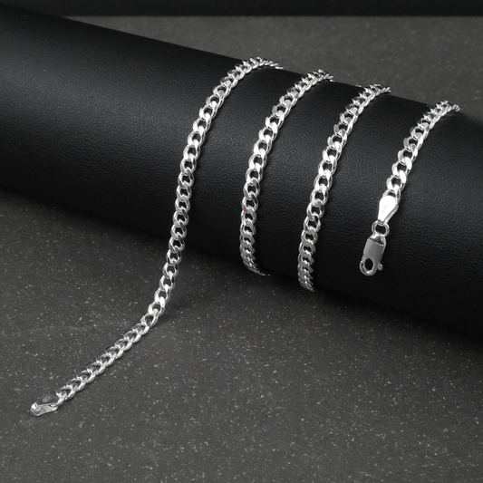 Silver curb chain on a dark surface