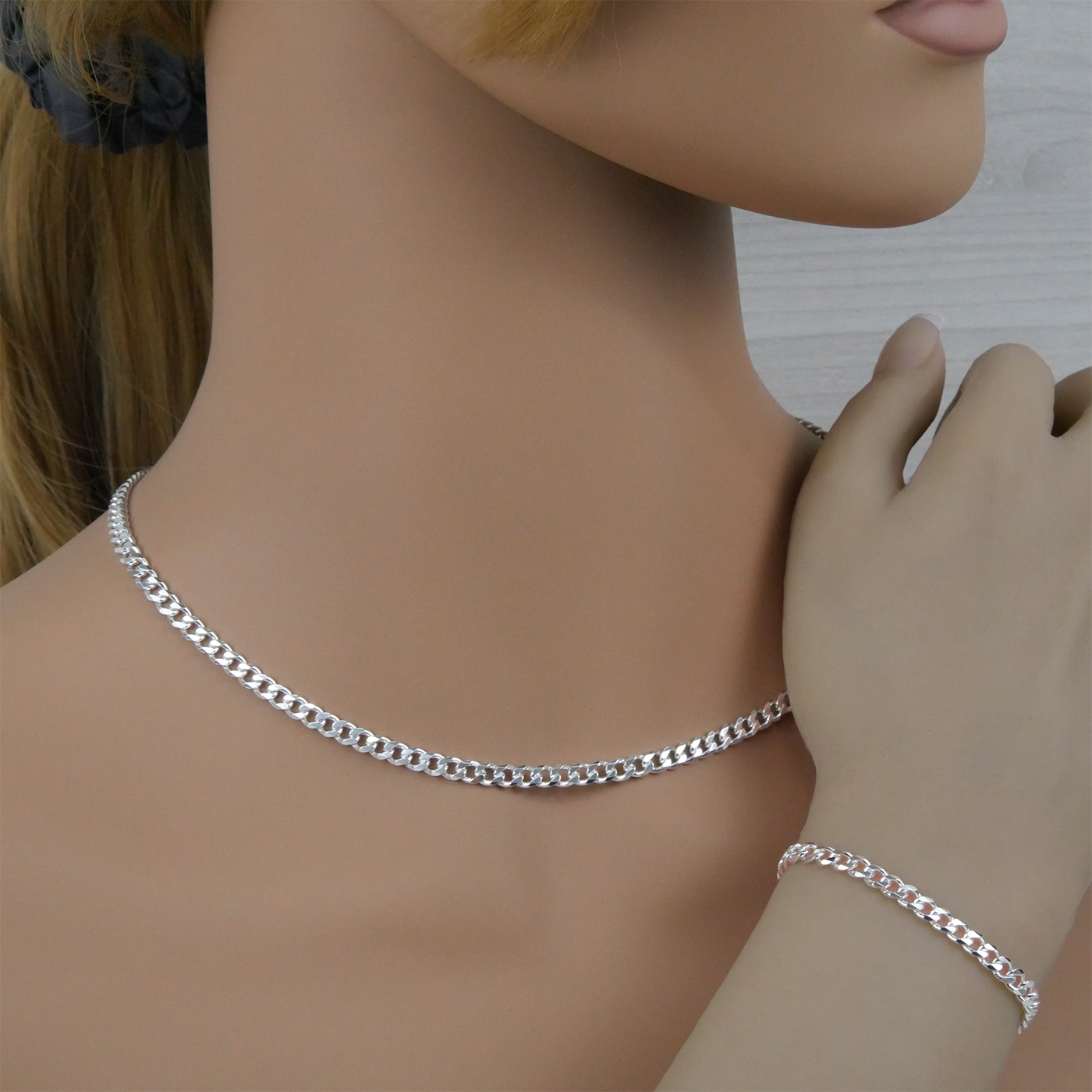 Silver curb chain necklace and bracelet on a mannequin