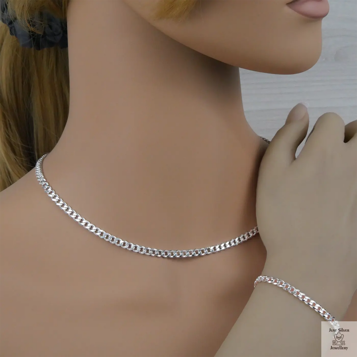 Silver curb chain necklace and bracelet on a mannequin