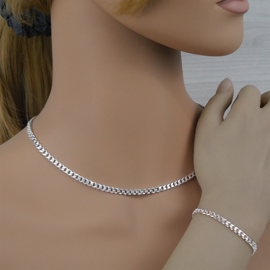 Silver curb chain necklace and bracelet on a mannequin