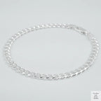 Silver bracelet on a light grey background