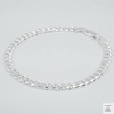 Silver bracelet on a light grey background