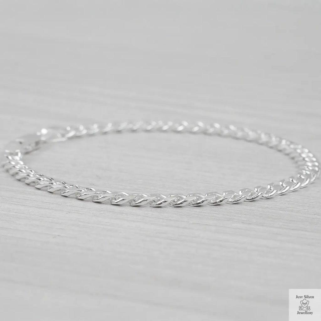 Silver curb bracelet on a light gray background