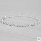 Silver curb bracelet on a light gray background