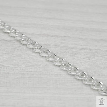 Silver chain on a light grey background
