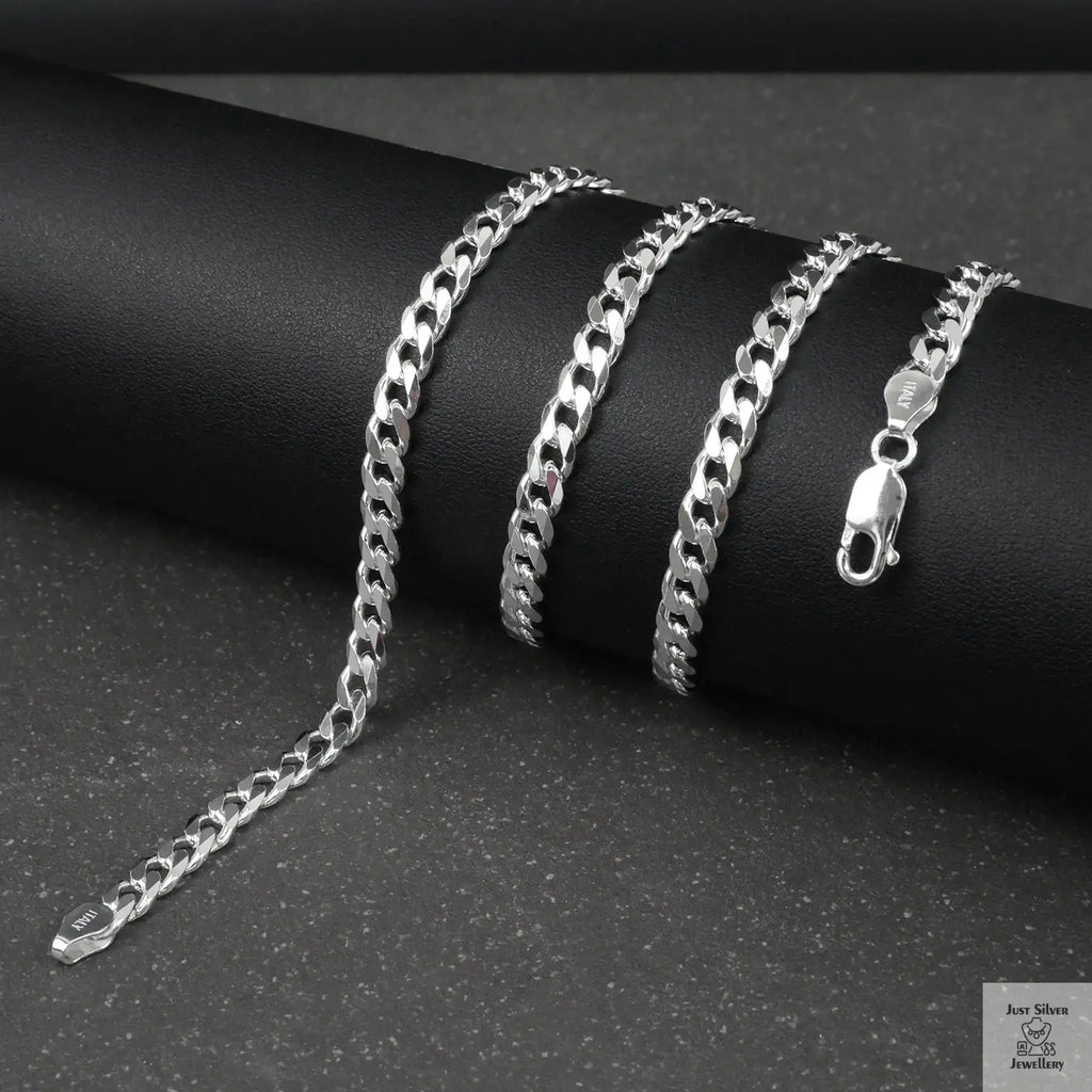 Silver curb chain on a dark surface