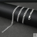 Silver curb chain on a dark surface