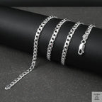 Silver curb chain on a dark surface