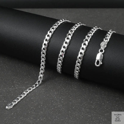 Silver curb chain on a dark surface