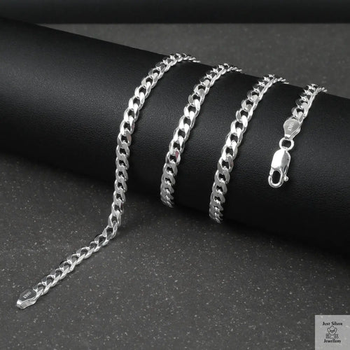Silver curb chain on a dark surface
