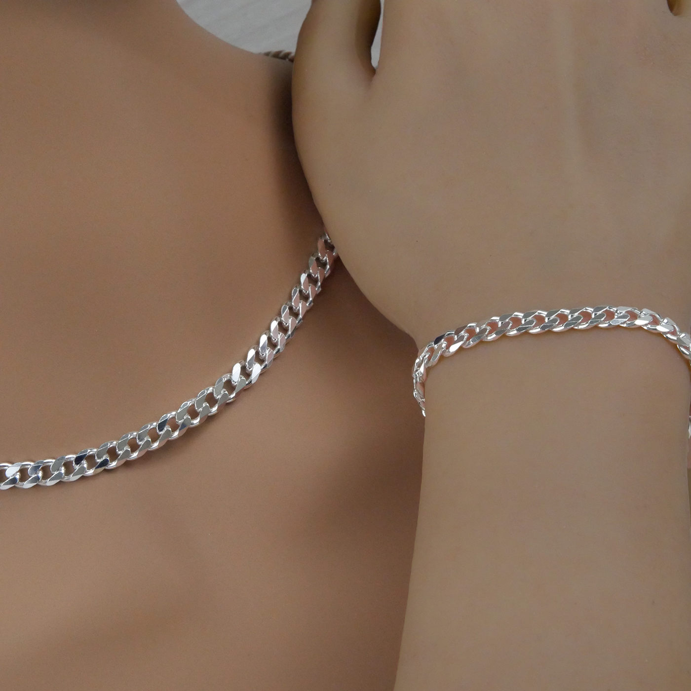 Silver curb chain necklace and bracelet on a mannequin