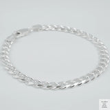 Silver bracelet on a light grey background