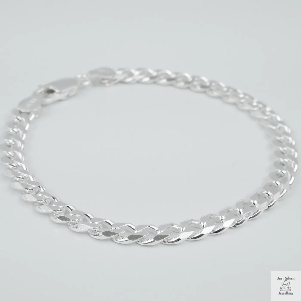 Silver bracelet on a light grey background