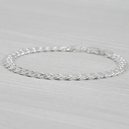 Silver bracelet on a light grey background