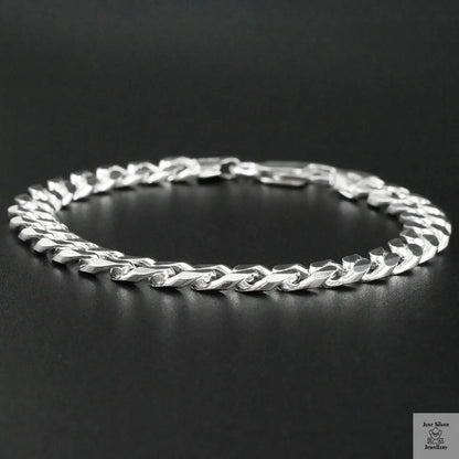 Silver chain bracelet on a black background