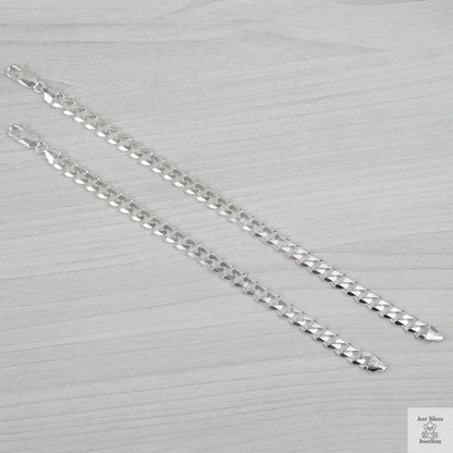Silver bracelets on a textured grey background