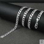 Silver curb chain on a dark surface