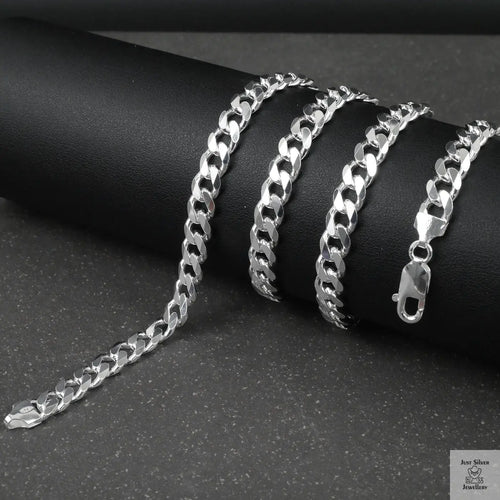 Silver curb chain on a dark surface