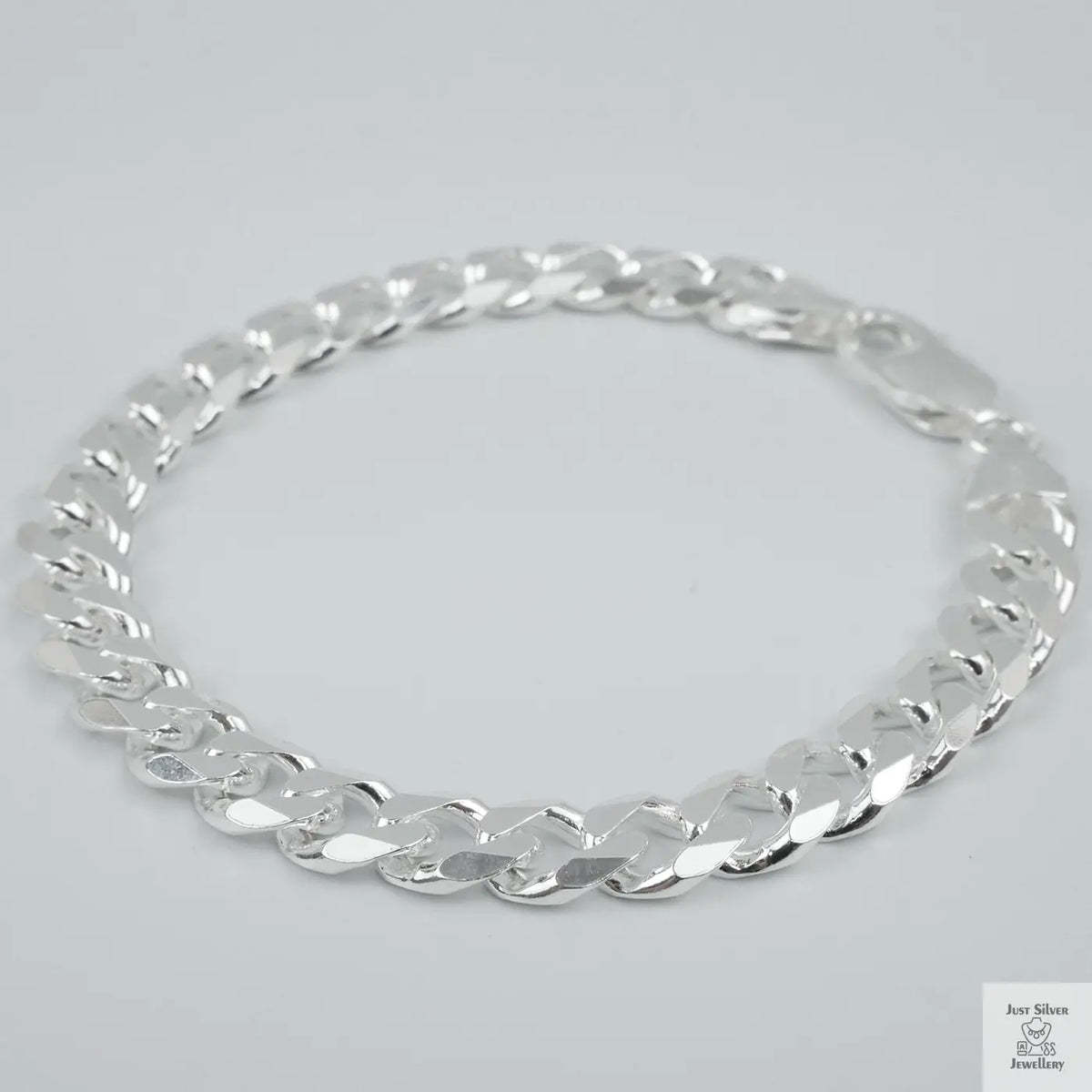 Silver bracelet on a light grey background
