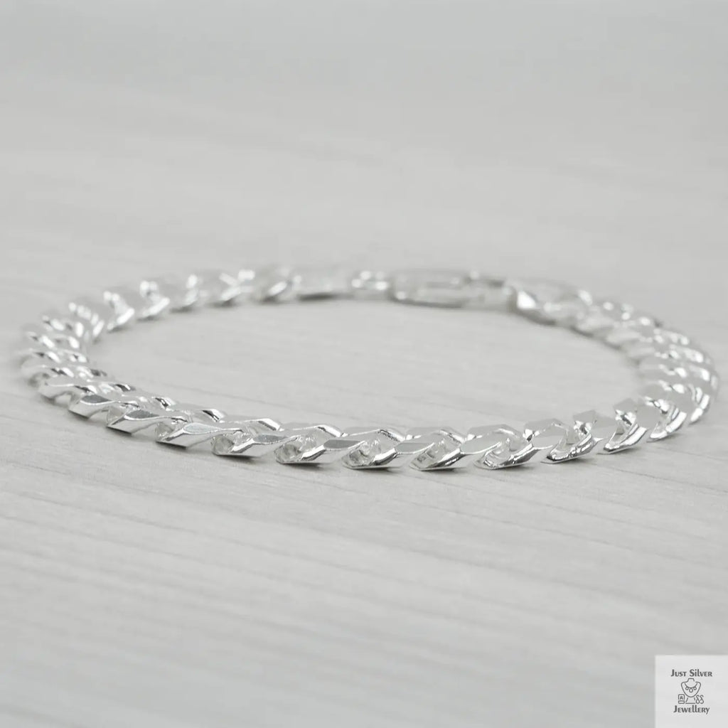 Silver bracelet on a light grey background