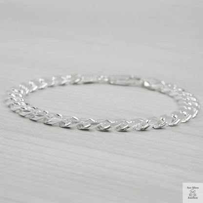Silver bracelet on a light grey background