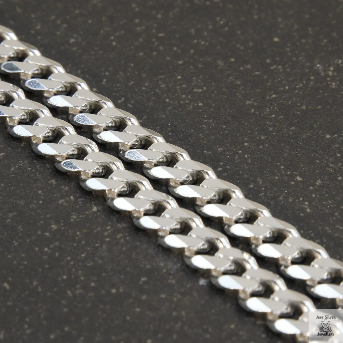 A solid sterling silver curb chain necklace with a 7mm link width, displayed against a white background.