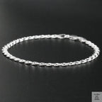 Silver chain bracelet on a black background