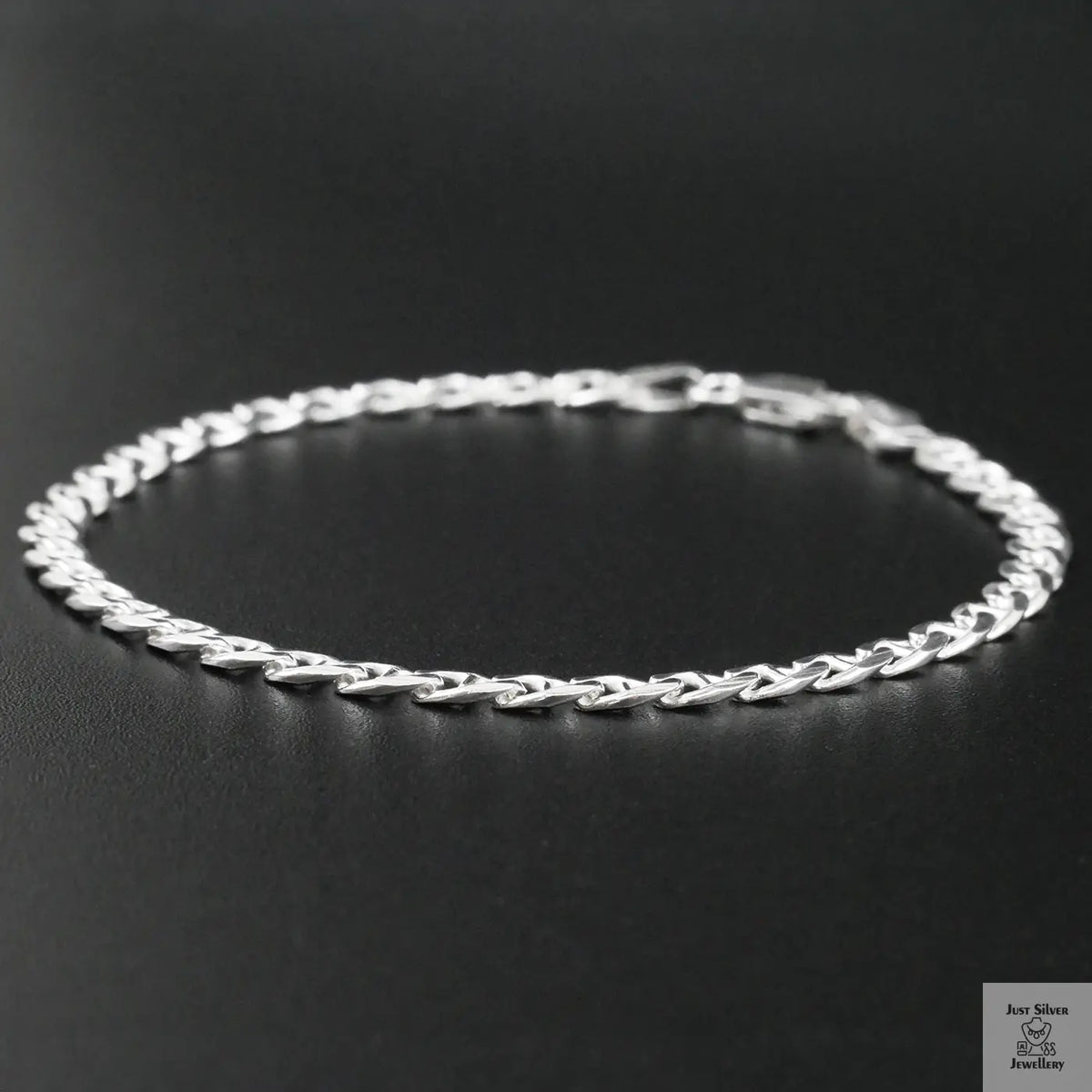 Silver chain bracelet on a black background