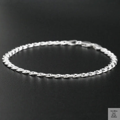 Silver chain bracelet on a black background