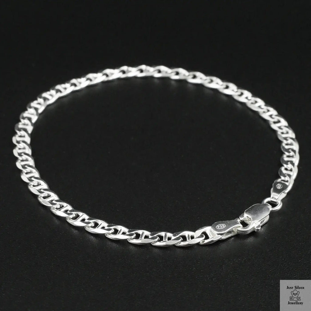 Silver chain bracelet on a black background