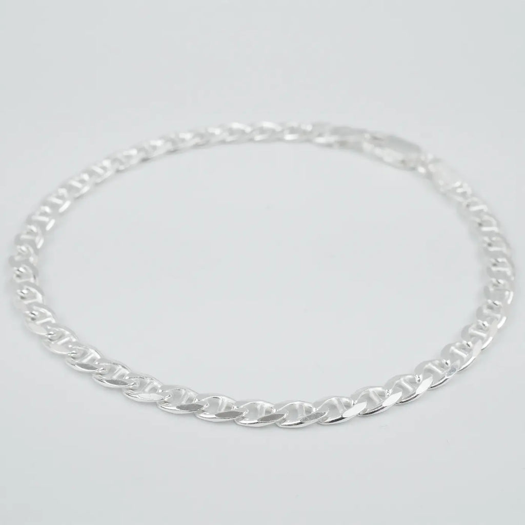 Silver marina link chain necklace on a light grey background
