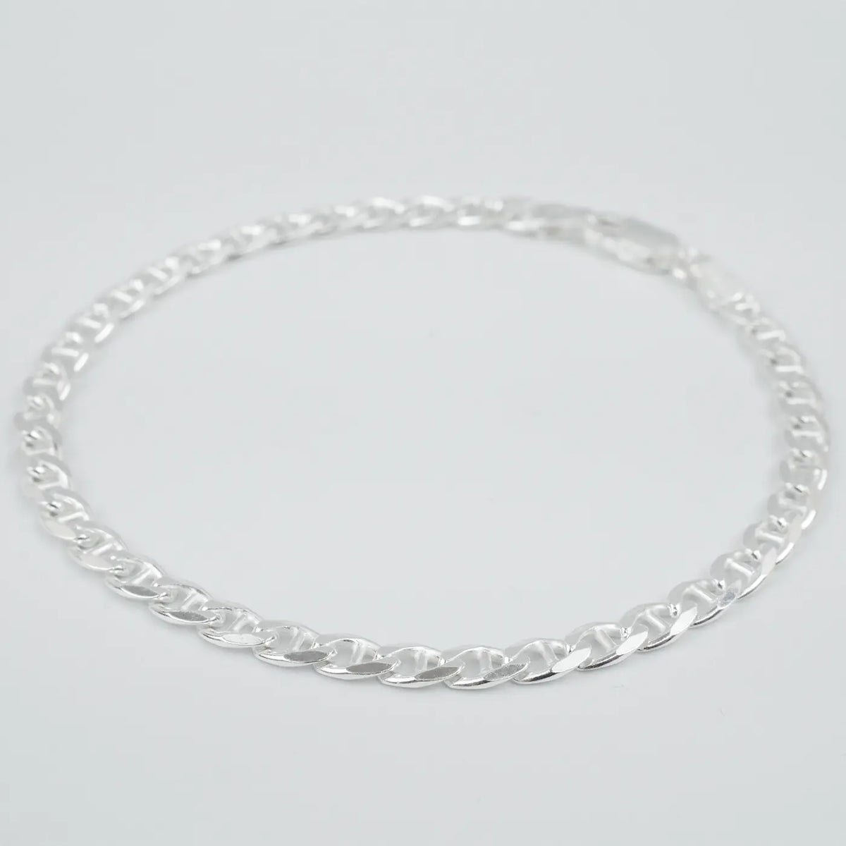 Silver marina link chain necklace on a light grey background