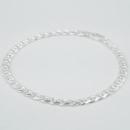 Silver marina link chain necklace on a light grey background