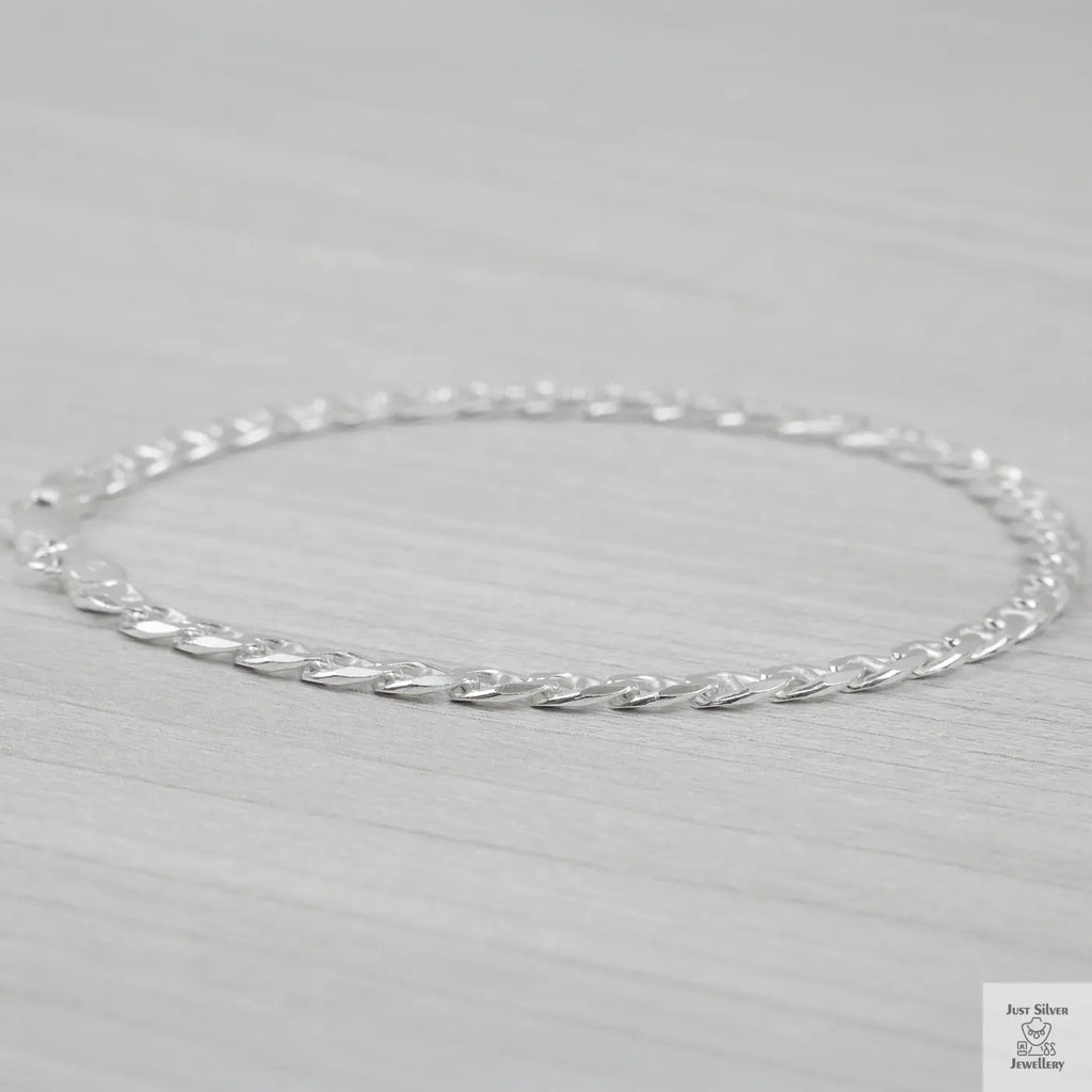 Silver marina link bracelet on a light gray background